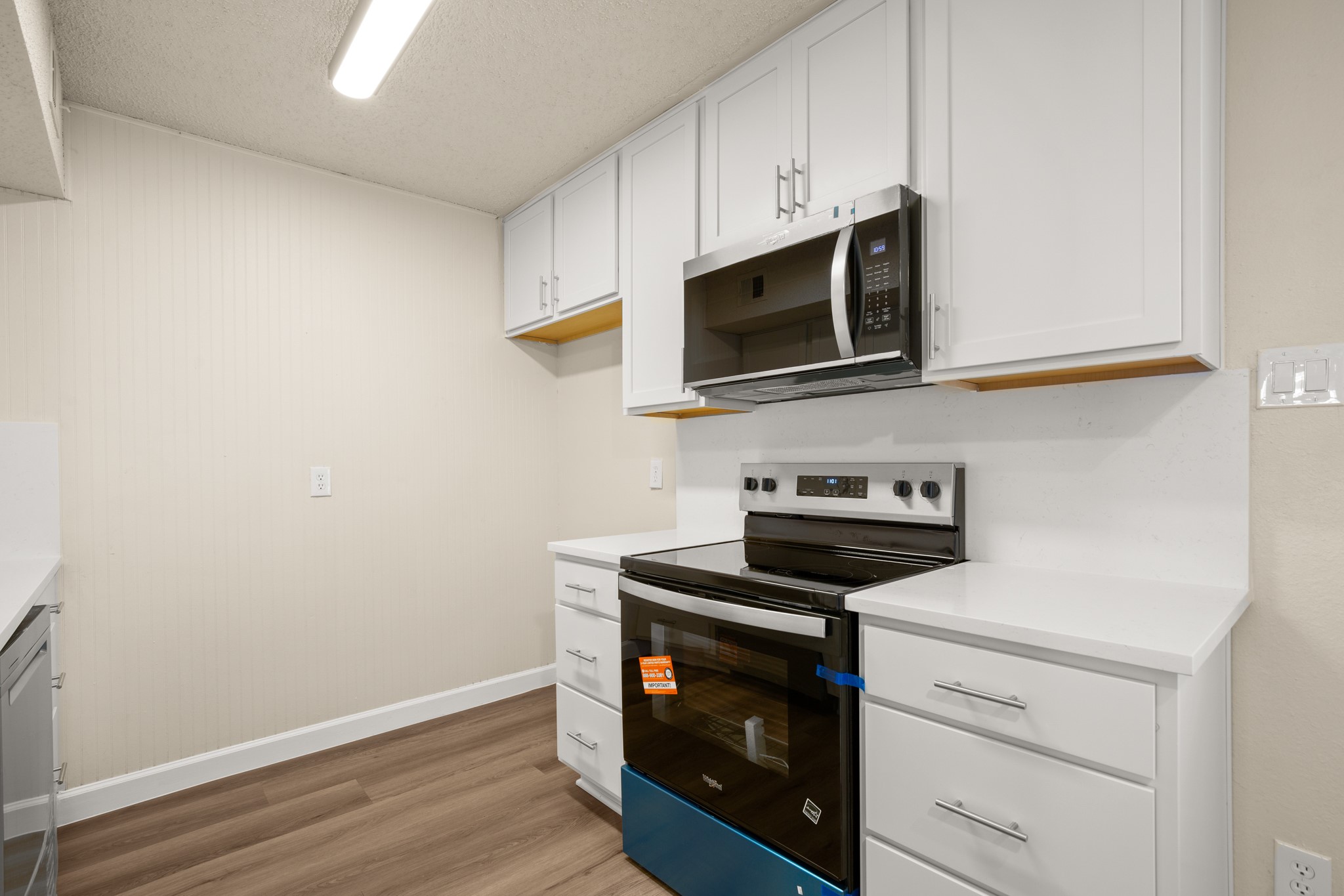 2408 Longview Street, Unit 112 Austin, TX 78705 - Photo 5 of 15 a kitchen with cabinets stainless steel appliances and wooden floor
