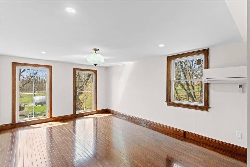 351 Engle Road Industry, PA 15052 - Photo 16 of 50 a view of an empty room with wooden floor and a window