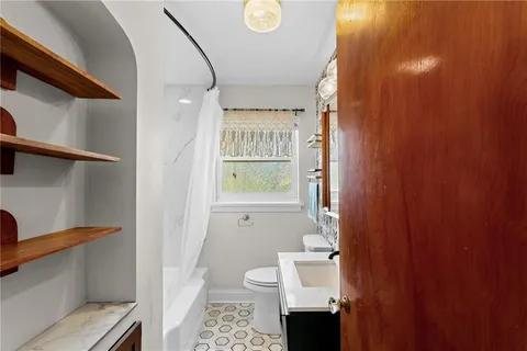 a bathroom with a toilet and a shower