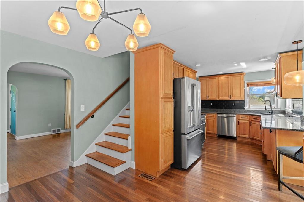 351 Engle Road Industry, PA 15052 - Photo 10 of 50 an empty room with wooden floor windows and a kitchen