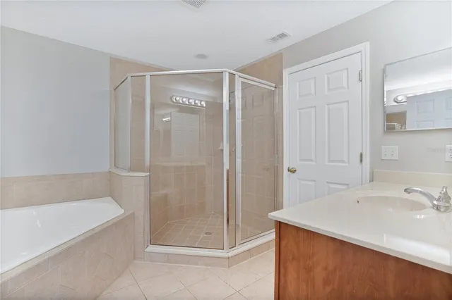 a bathroom with a shower and a sink