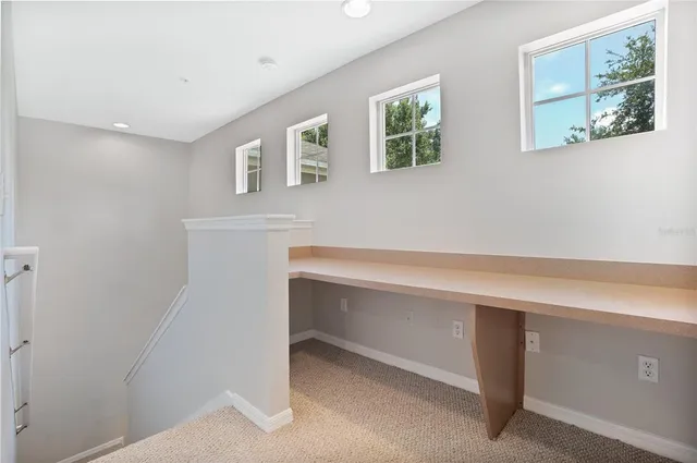 a room with window and a desk