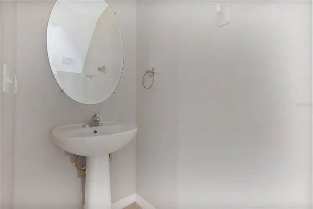 a bathroom with a sink and mirror