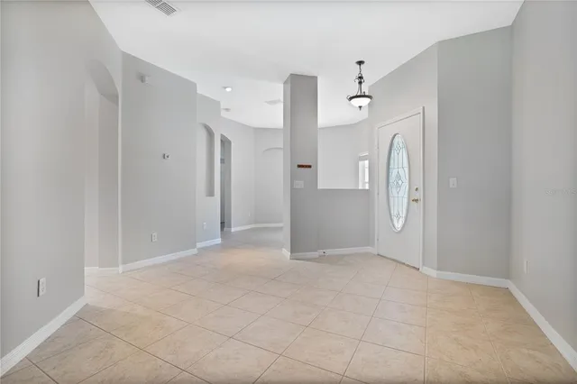 a view of a big room with closet and windows