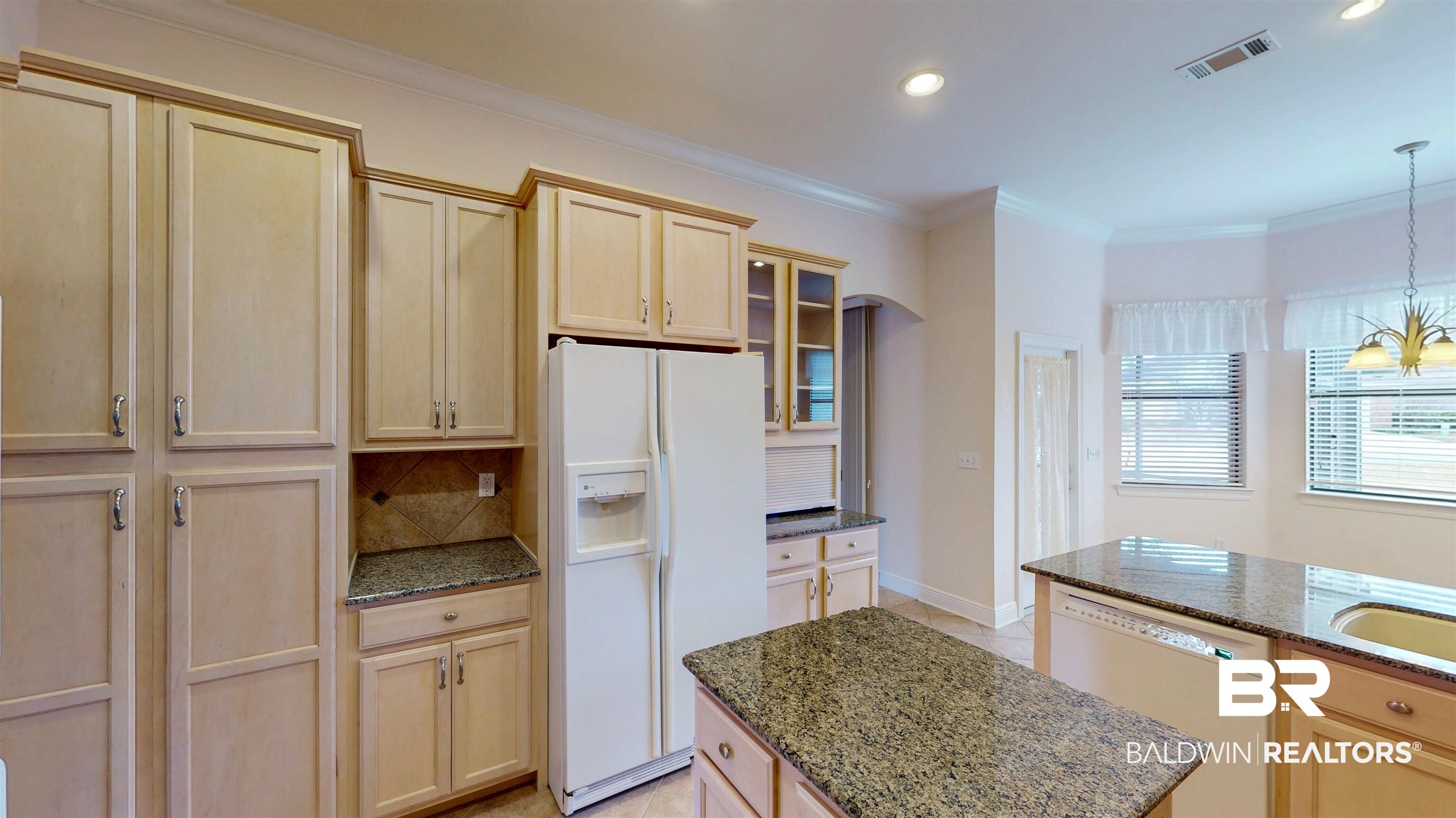 214 Hemingway Loop Foley, AL 36535 - Photo 15 of 67 Kitchen featuring light brown cabinetry, white appliances, dark stone countertops, a center island, and glass insert cabinets