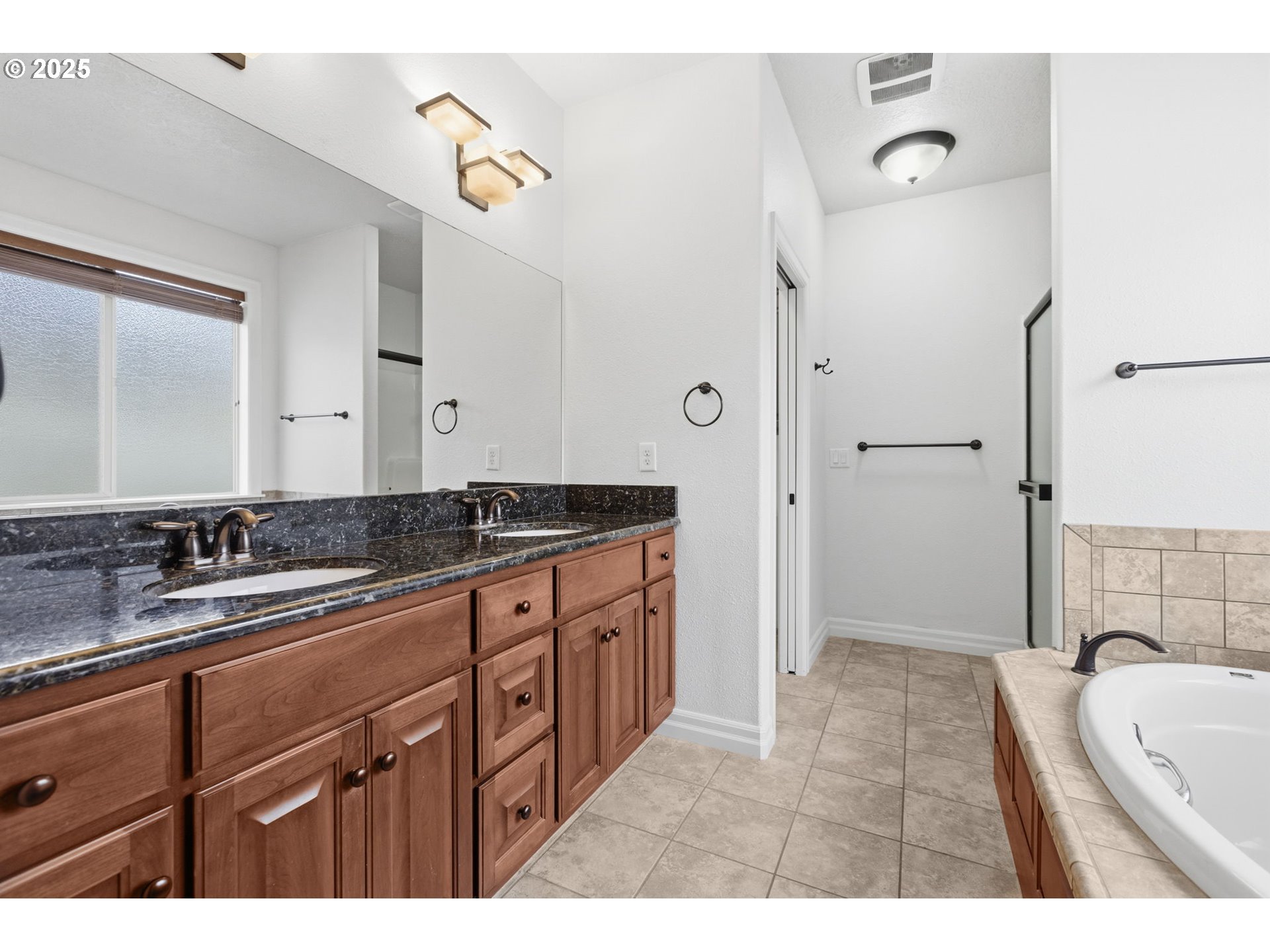 4879 Northeast Granite Avenue Albany, OR 97321 - Photo 11 of 47 a spacious bathroom with a granite countertop sink mirror and bathtub