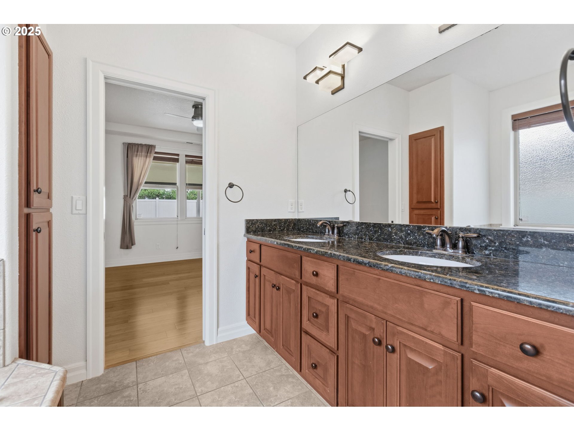 4879 Northeast Granite Avenue Albany, OR 97321 - Photo 15 of 47 a bathroom with a granite countertop sink and a mirror