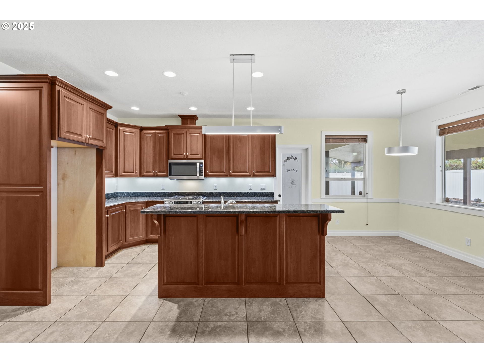 4879 Northeast Granite Avenue Albany, OR 97321 - Photo 24 of 47 a kitchen with stainless steel appliances granite countertop a refrigerator and a sink