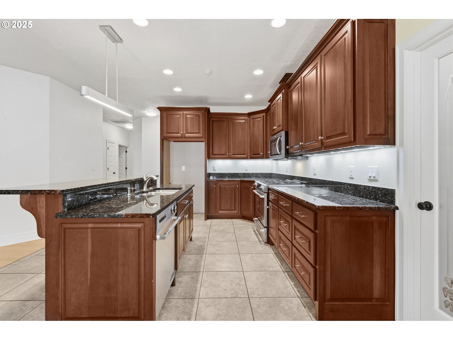 4879 Northeast Granite Avenue Albany, OR 97321 - Photo 26 of 47 a kitchen with stainless steel appliances granite countertop a stove a sink dishwasher and a refrigerator