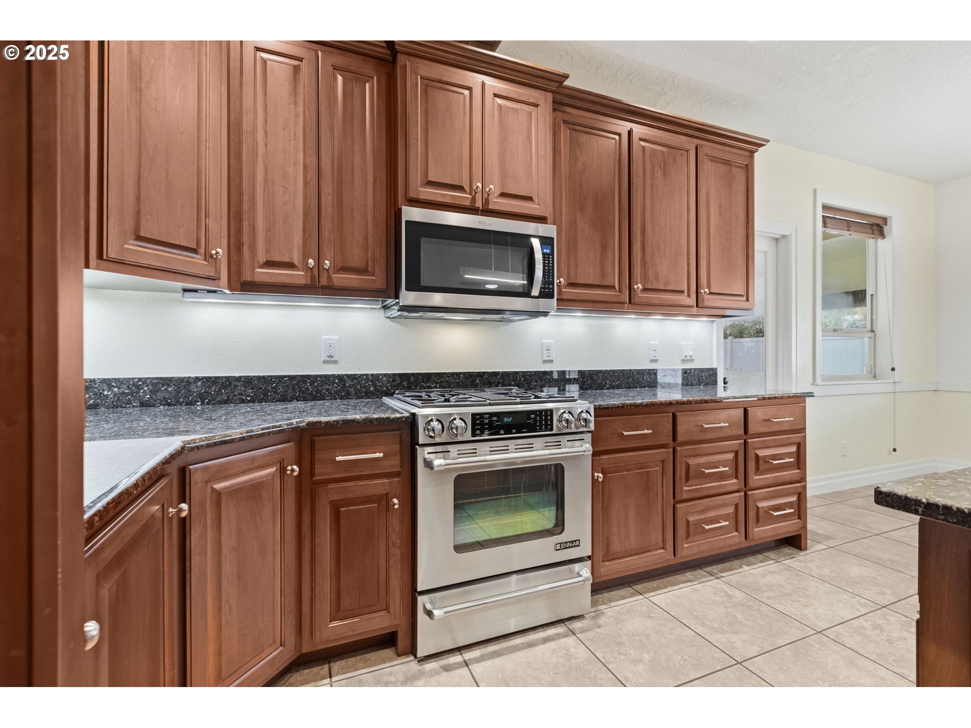4879 Northeast Granite Avenue Albany, OR 97321 - Photo 28 of 47 a kitchen with granite countertop wooden cabinets and stainless steel appliances