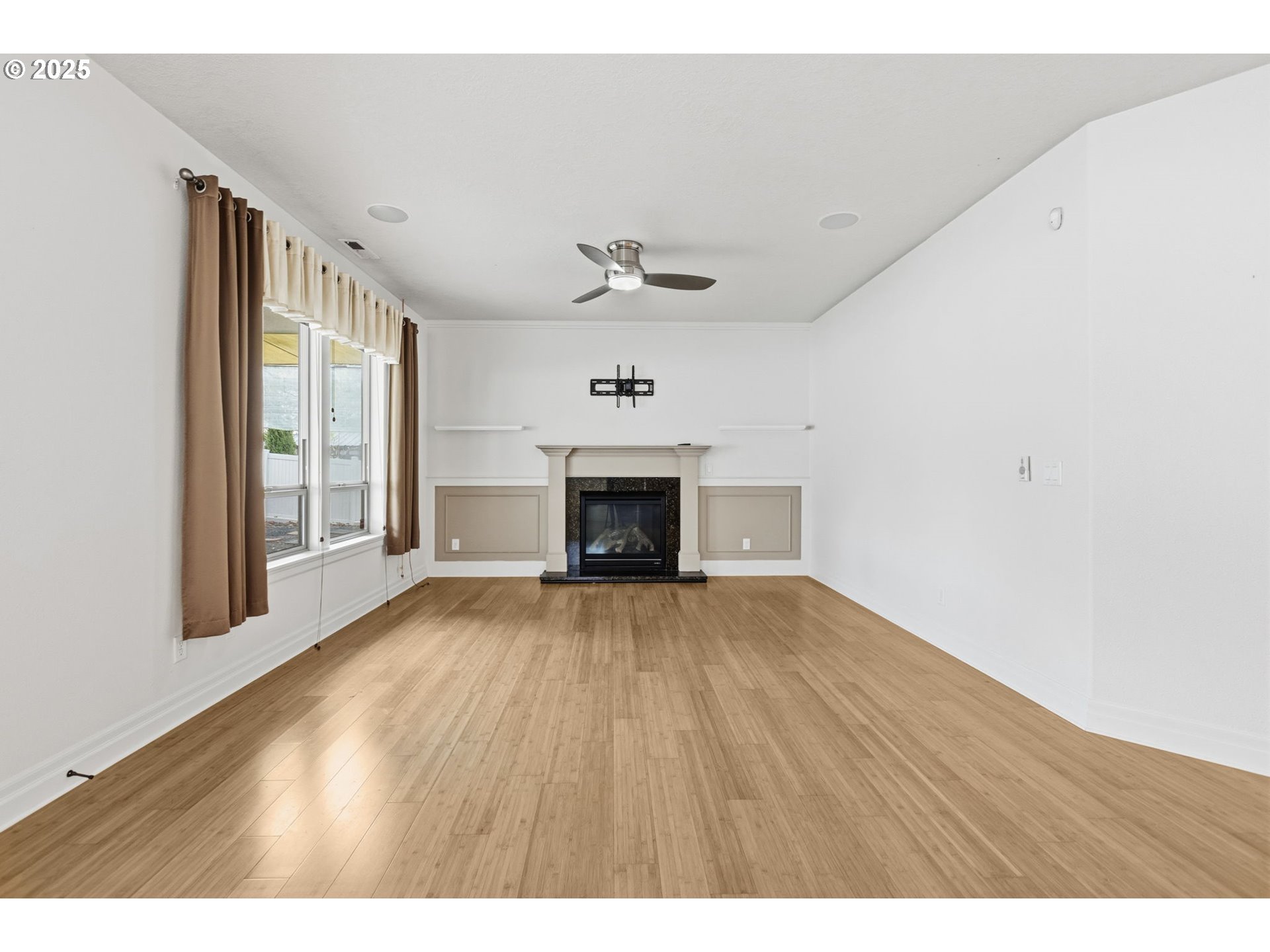 4879 Northeast Granite Avenue Albany, OR 97321 - Photo 31 of 47 a view of an empty room with a fireplace and a window