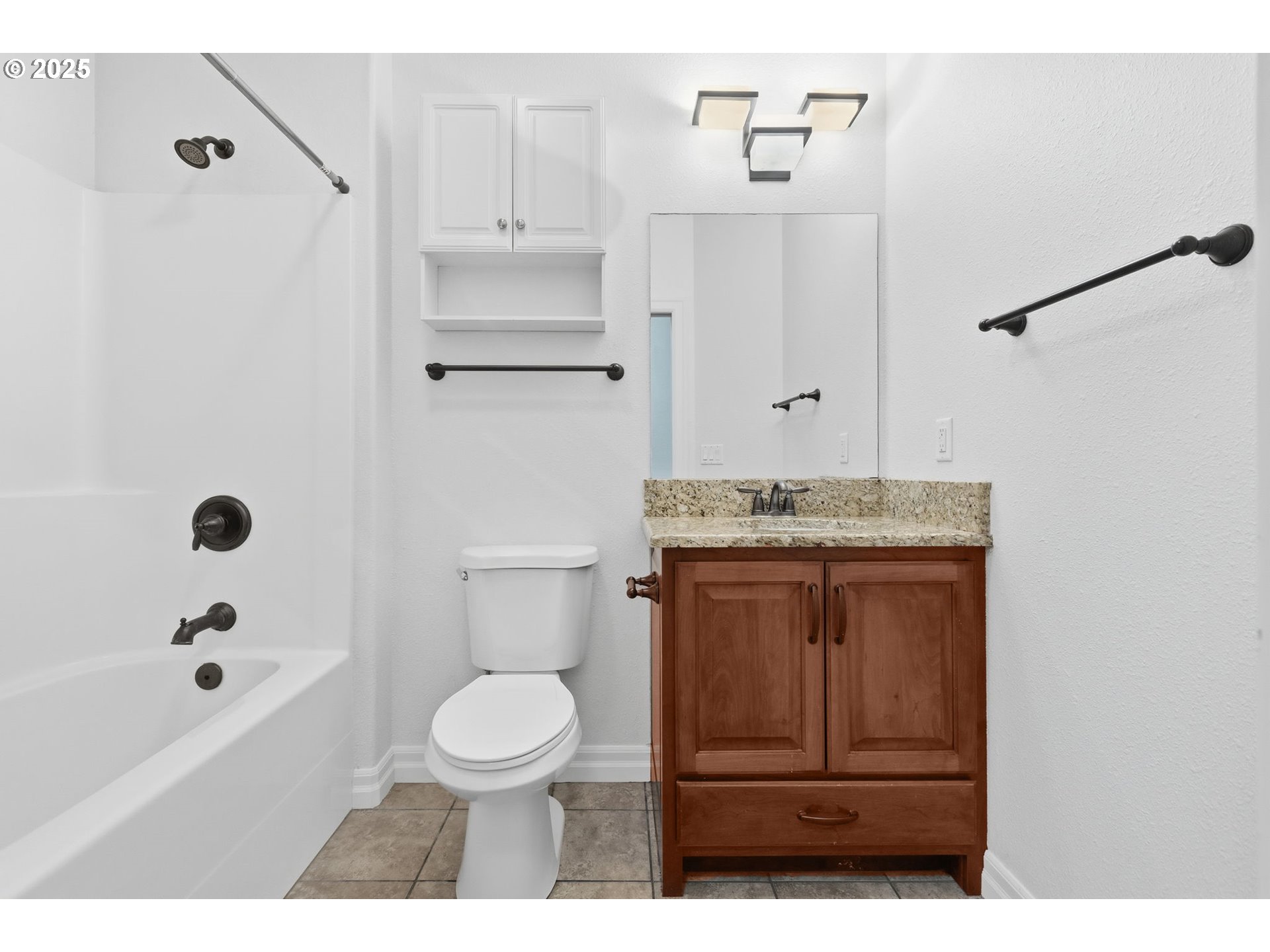 4879 Northeast Granite Avenue Albany, OR 97321 - Photo 36 of 47 a bathroom with a granite countertop sink toilet a mirror and shower
