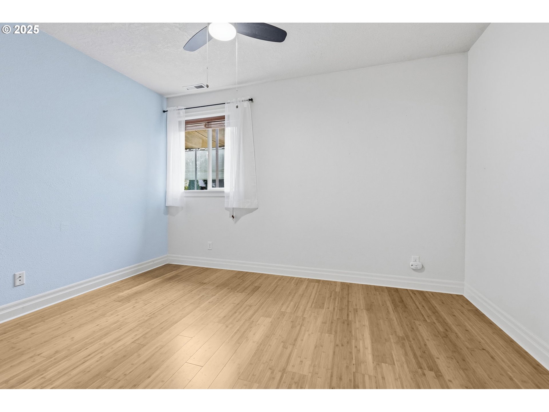 4879 Northeast Granite Avenue Albany, OR 97321 - Photo 37 of 47 a view of an empty room with wooden floor and a window