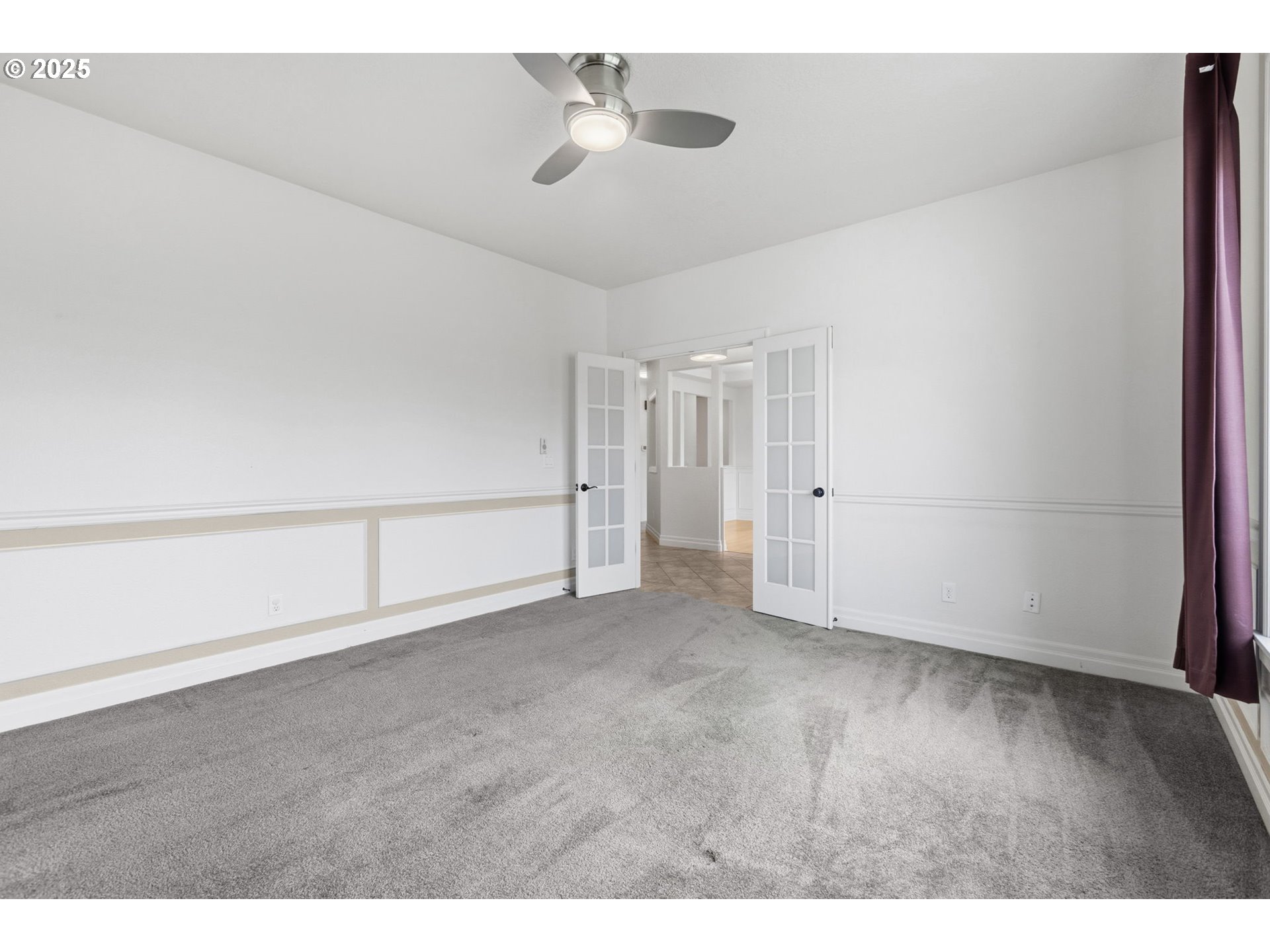 4879 Northeast Granite Avenue Albany, OR 97321 - Photo 6 of 47 a view of an empty room with a ceiling fan