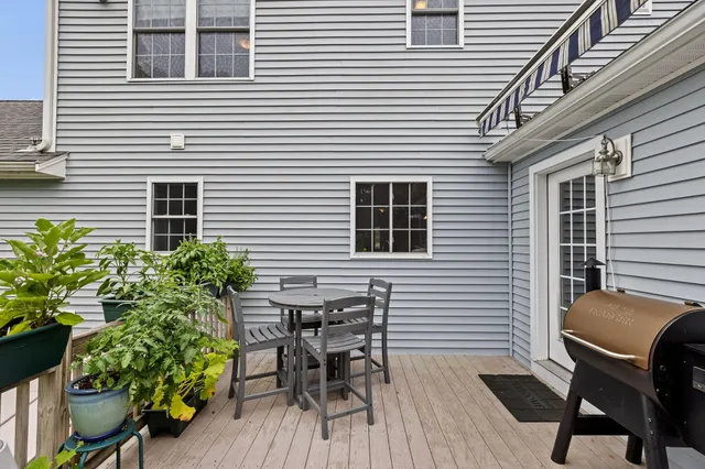 a backyard of a house with wooden seating space