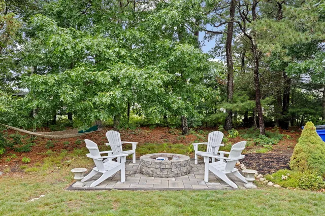 a view of a chair and table on the garden