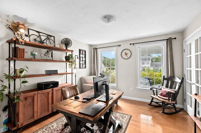 a living room with furniture and wooden floor