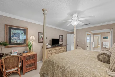 a spacious bedroom with a bed and a flat screen tv