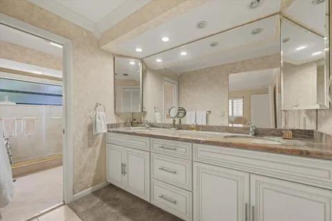 a bathroom with double sink and a mirror