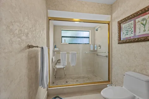 a bathroom with a shower a toilet and a sink