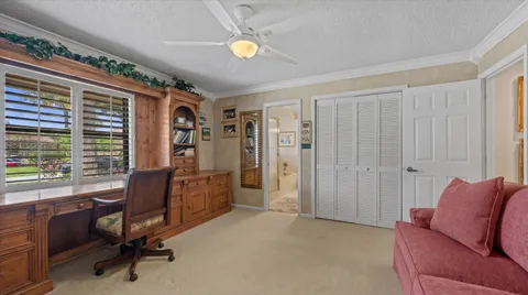 a view of a livingroom with workspace and a window
