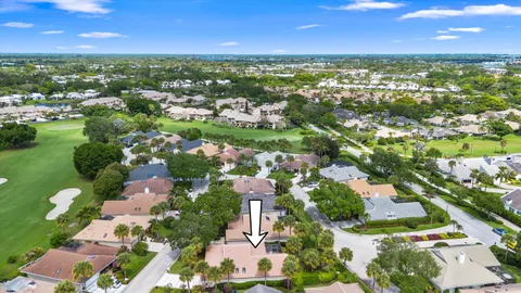an aerial view of residential houses with outdoor space and trees all around