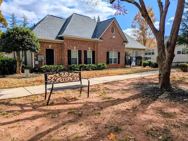 a wooden bench sitting in front of a house