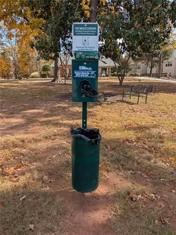 a view of a house with a yard and a car parked on the road