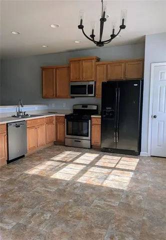 a kitchen with stainless steel appliances granite countertop a sink and cabinets