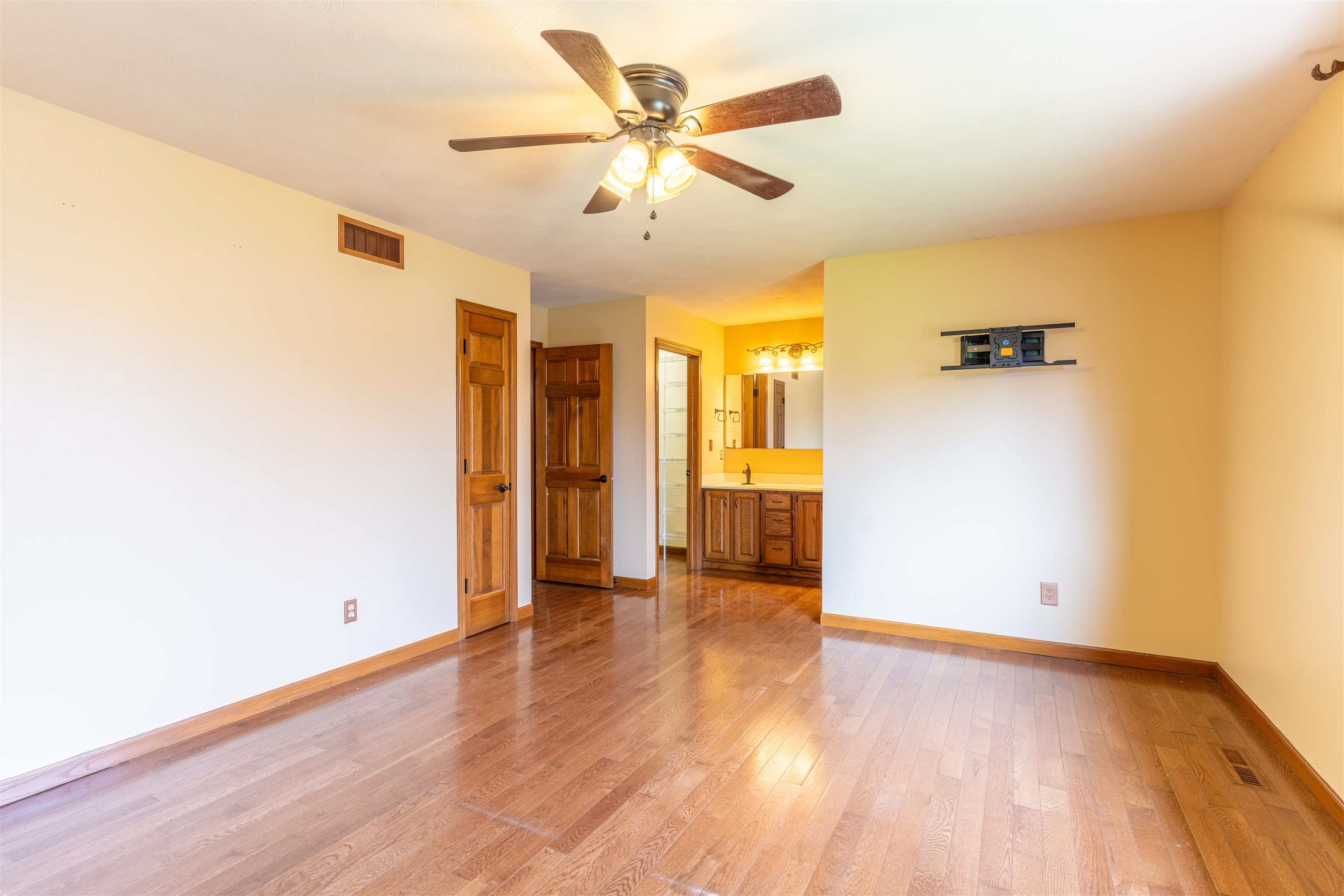 151 North Fox Run Lane Byron, IL 61010 - Photo 14 of 37 an empty room with wooden floor and a ceiling fan