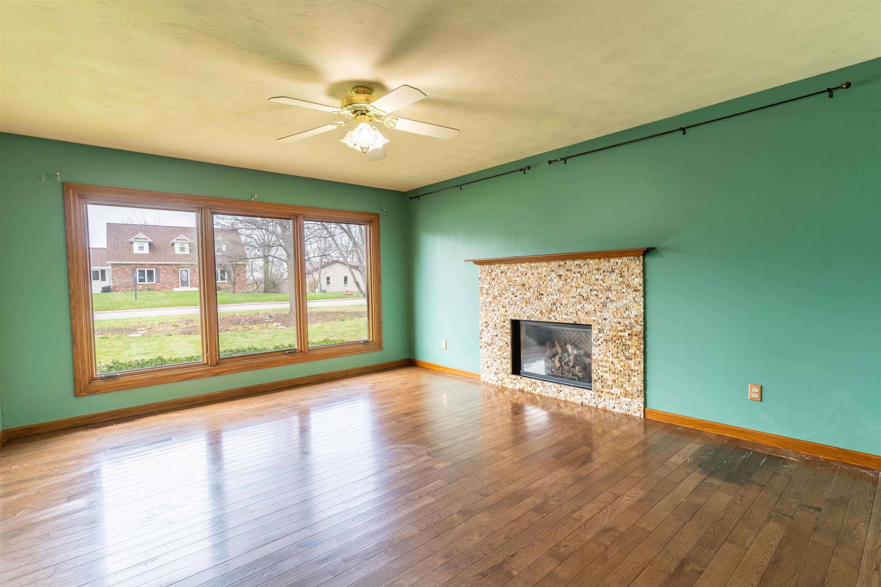 151 North Fox Run Lane Byron, IL 61010 - Photo 3 of 37 a view of an empty room with window and wooden floor