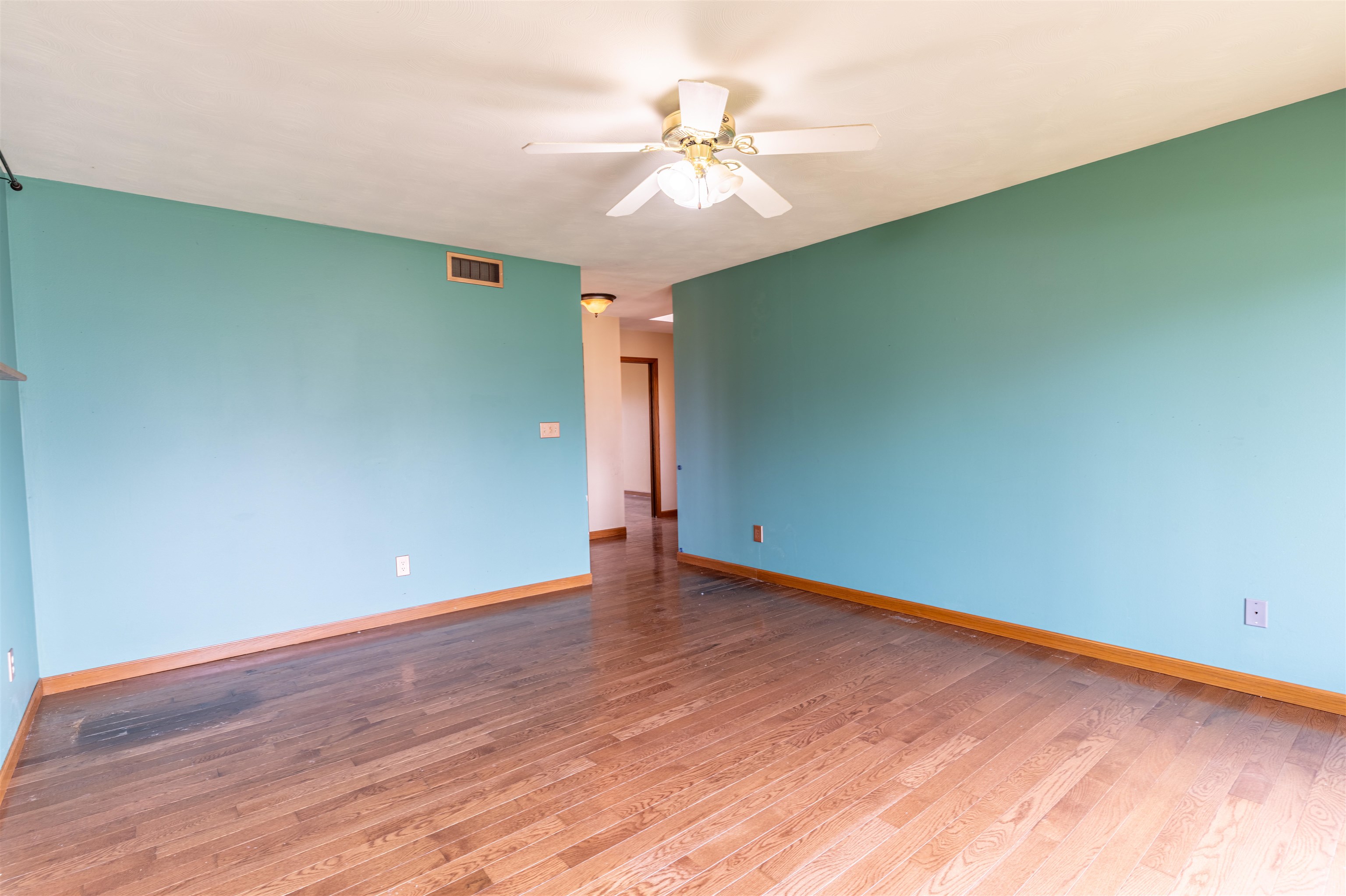 151 North Fox Run Lane Byron, IL 61010 - Photo 4 of 37 an empty room with wooden floor and fan