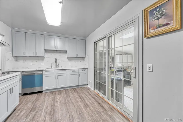 a kitchen with granite countertop a stove top oven sink and cabinets