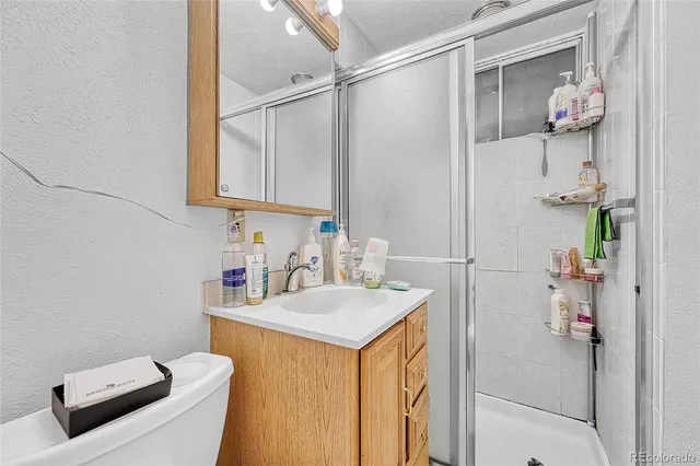 a living room with furniture a flat screen tv and a floor to ceiling window