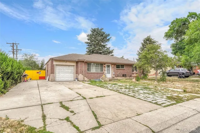 a view of a house with a yard and potted plants