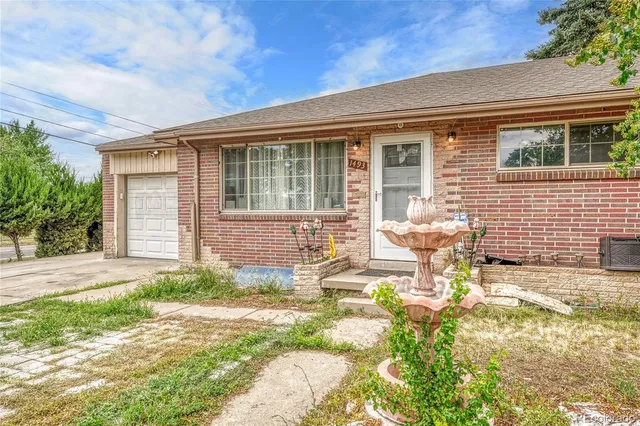 a view of house with backyard and sitting area