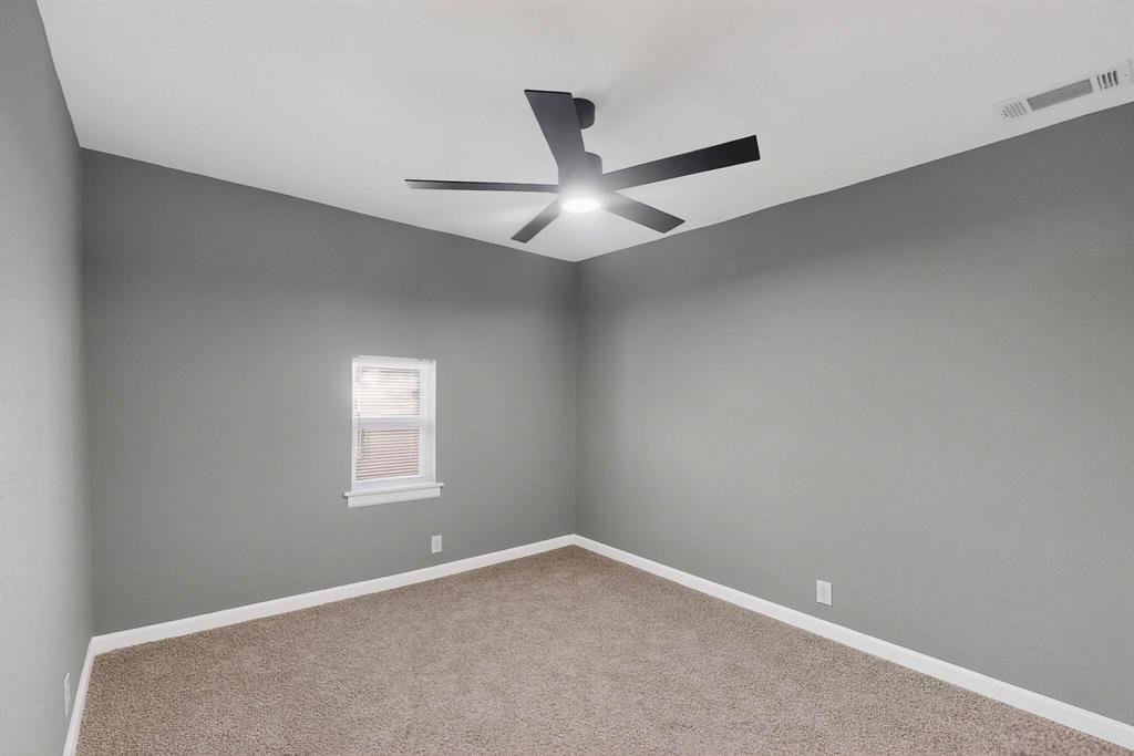 3442 Tioga Street Dallas, TX 75241 - Photo 21 of 28 an empty room with a window and ceiling fan