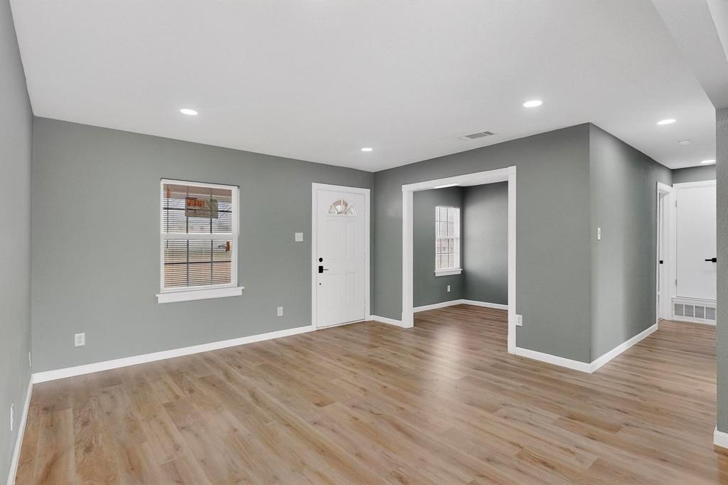 3442 Tioga Street Dallas, TX 75241 - Photo 6 of 28 a view of an empty room with wooden floor and a window