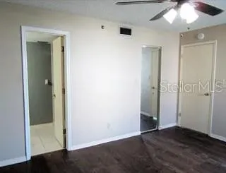 an empty room with wooden floor and closet