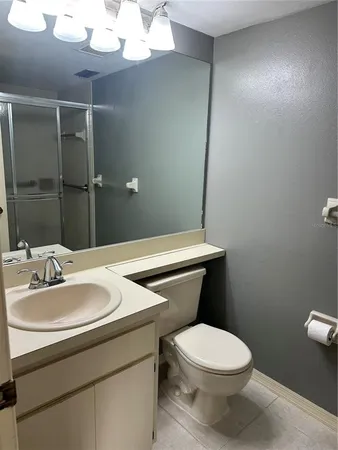 a bathroom with a glass shower door