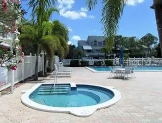 a view of a swimming pool with a patio and a yard