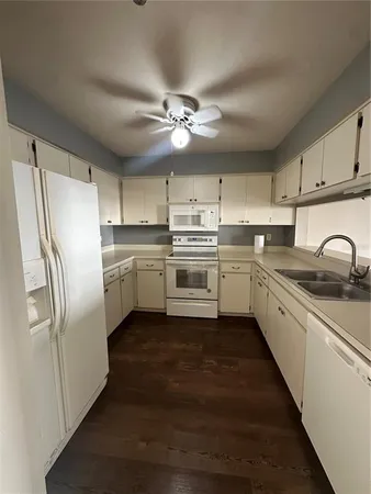 a kitchen with stainless steel appliances a refrigerator sink and cabinets