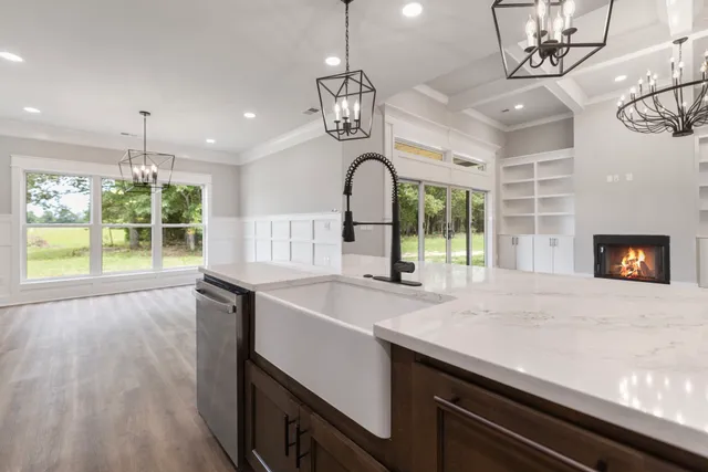 a kitchen with a sink and wooden floor
