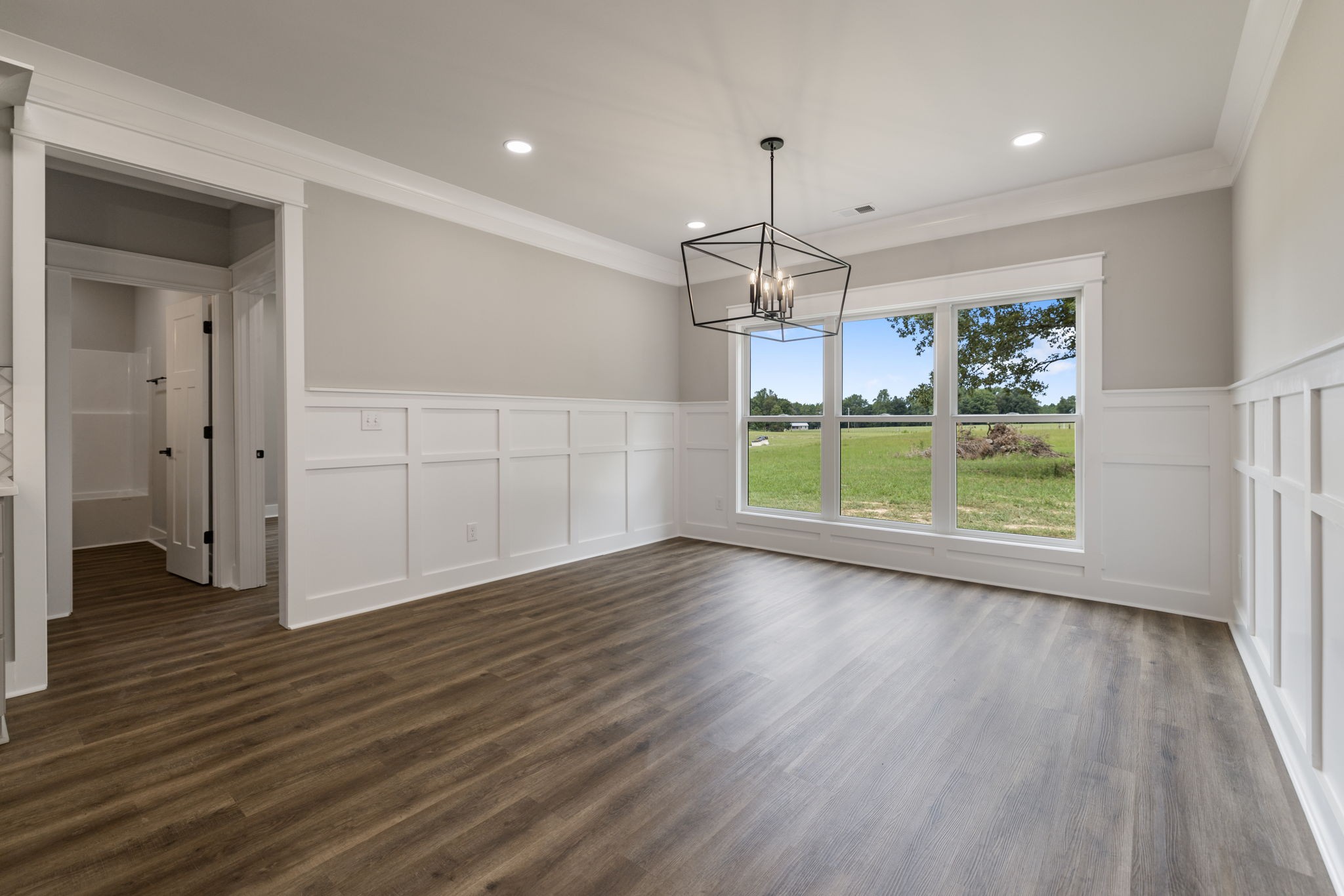 887 Ovoca Lake Road Tullahoma, TN 37388 - Photo 24 of 58 an empty room with wooden floor cabinet and windows