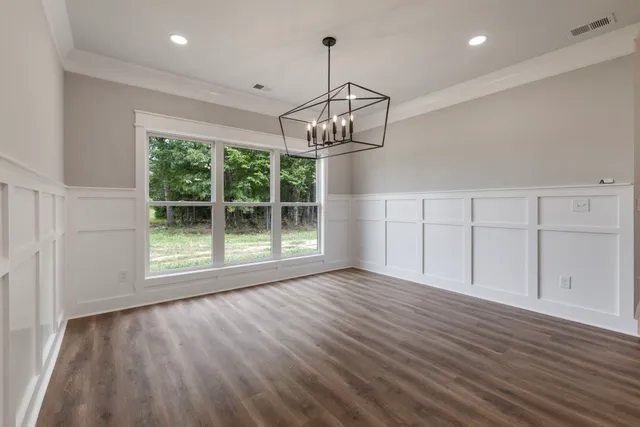 a view of empty room with wooden floor and outdoor view