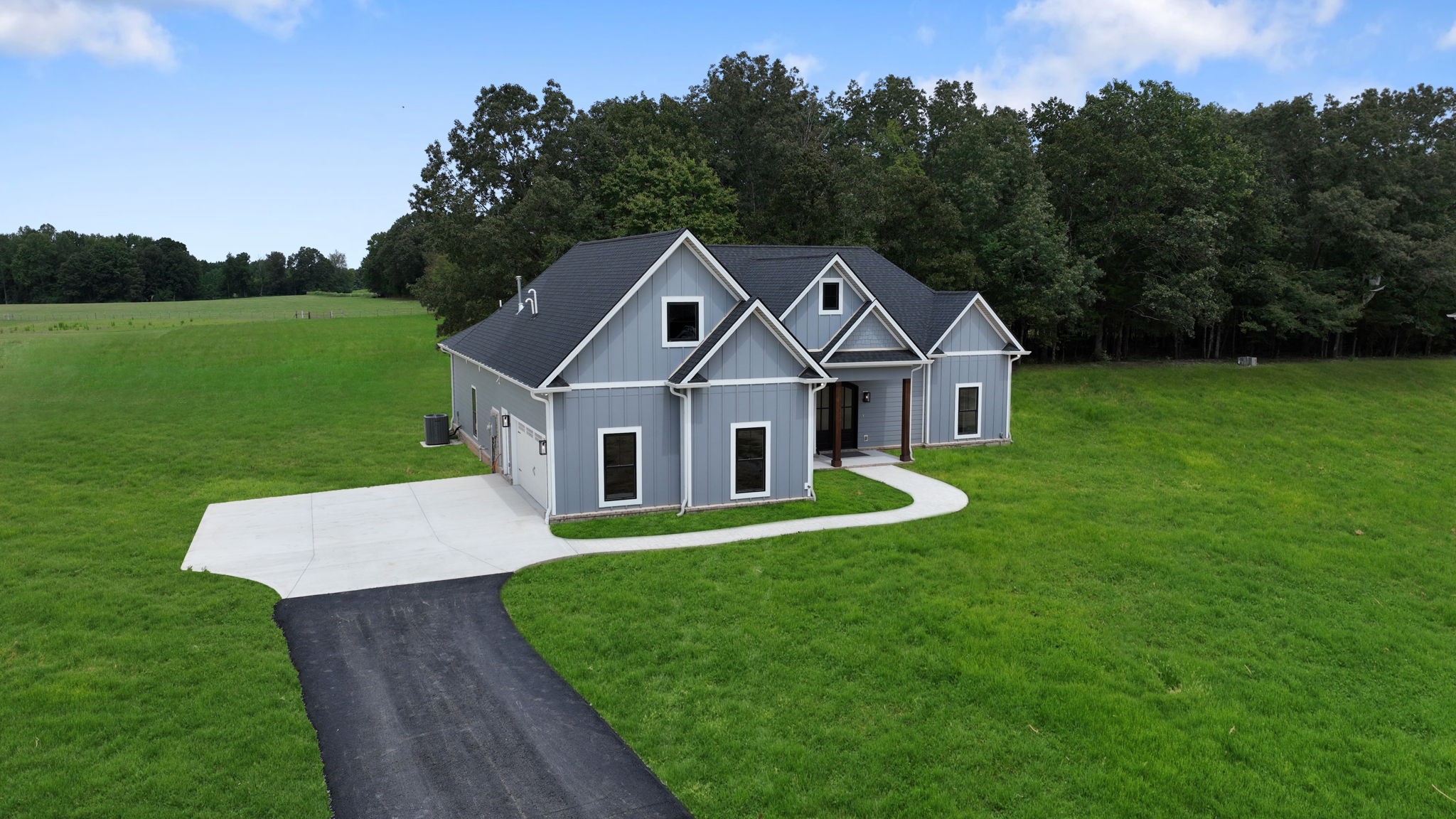 887 Ovoca Lake Road Tullahoma, TN 37388 - Photo 5 of 58 a front view of a house with a yard and trees