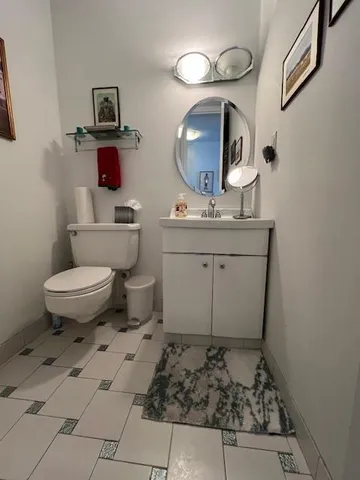 a bathroom with a toilet sink and mirror