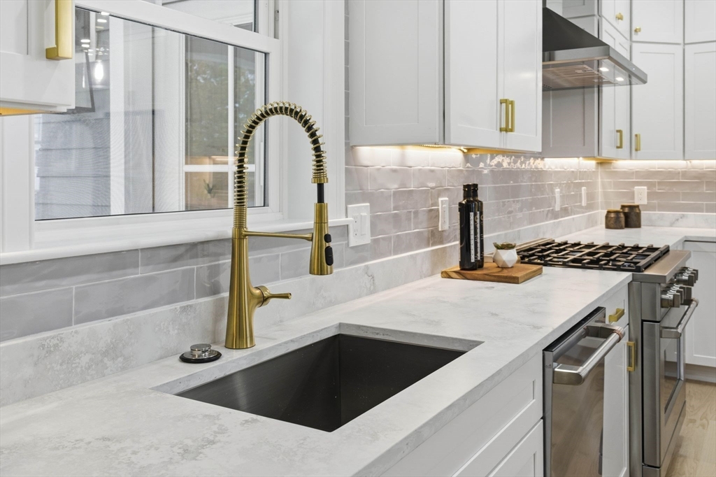 4 Chatham Lane Danvers, MA 01923 - Photo 11 of 40 a kitchen with a sink and a stove with a granite countertops