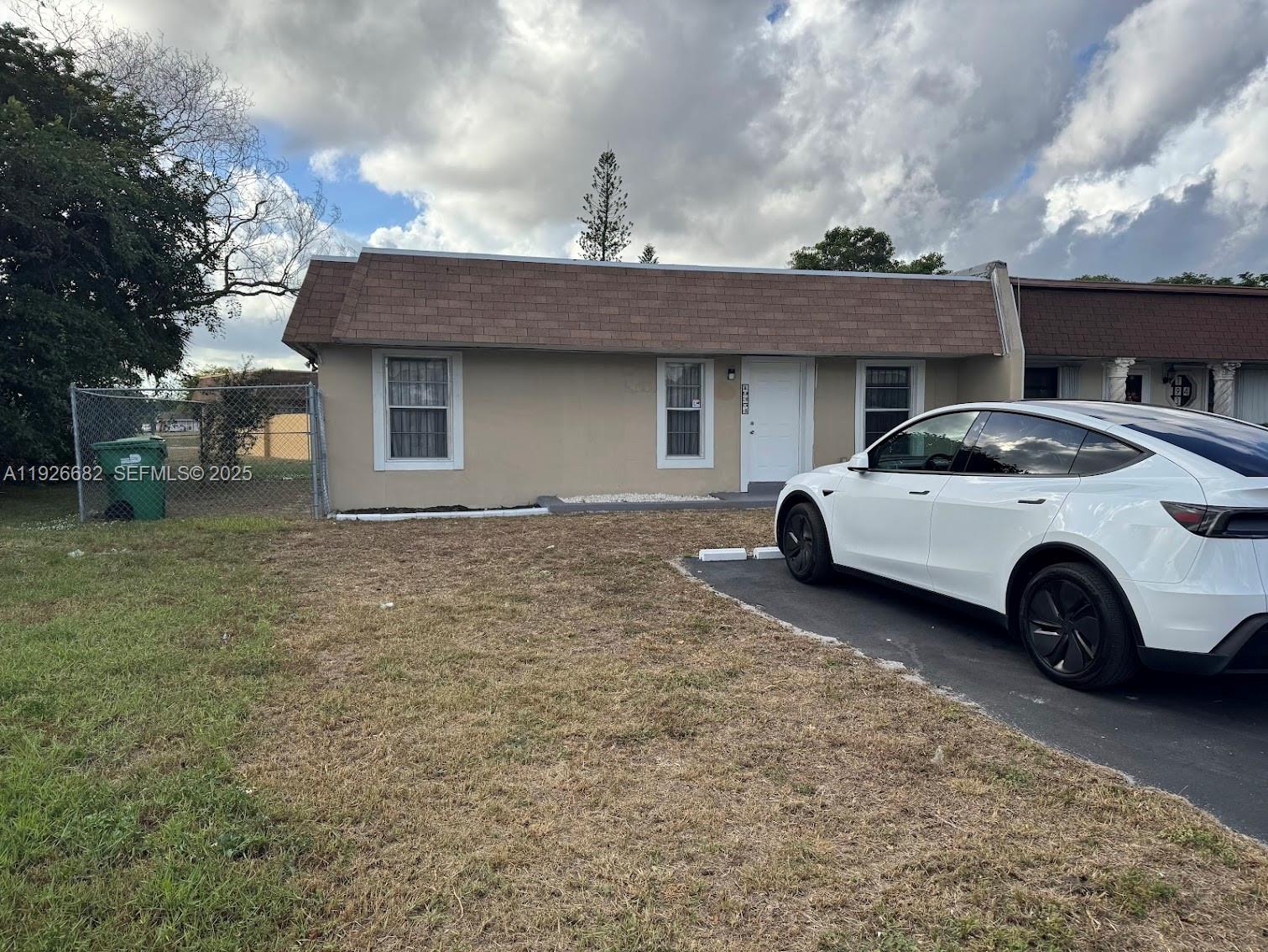 a view of a car parked in front of a house
