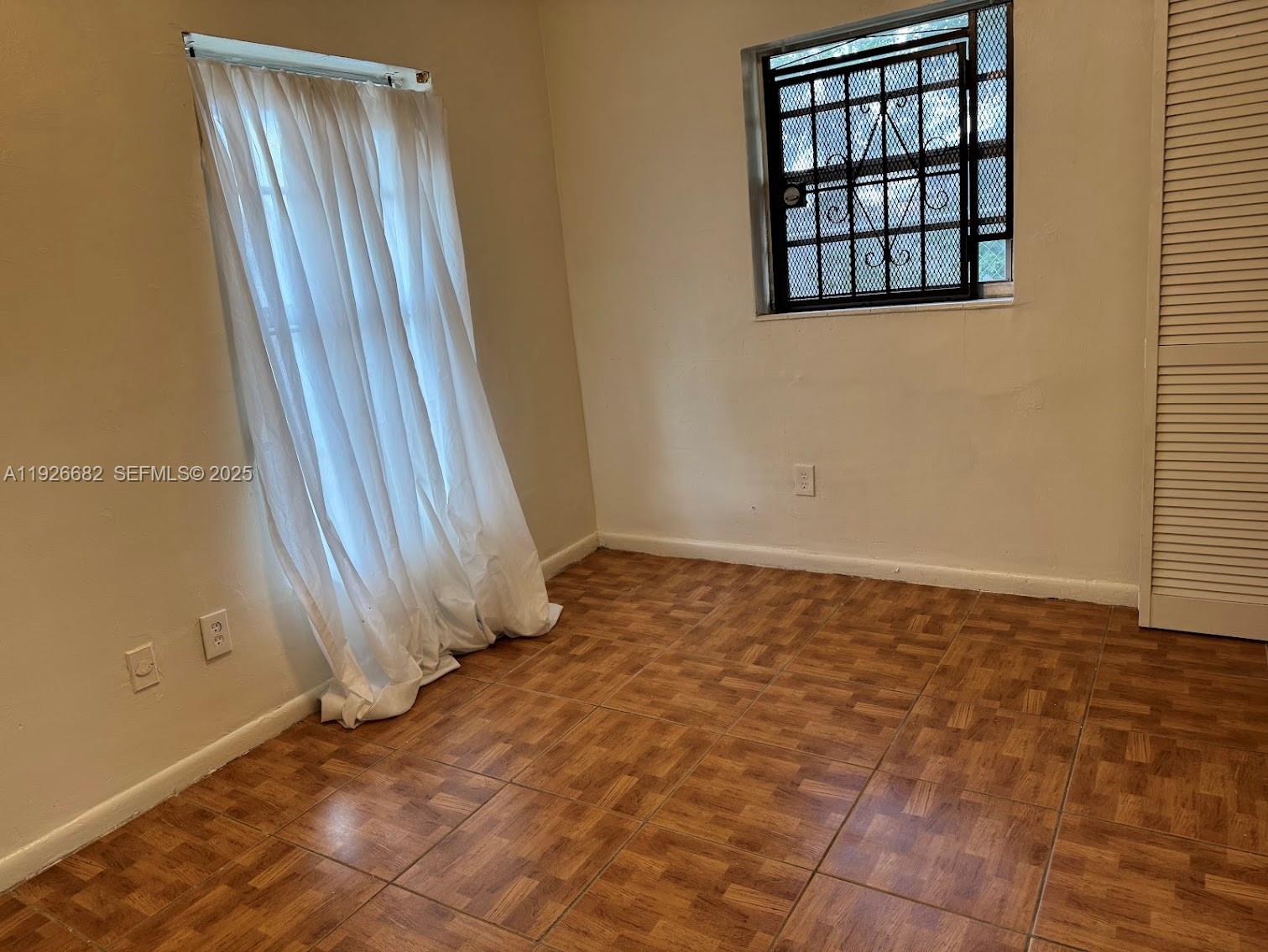 19354 Northwest 28th Court, Unit 19354 Miami Gardens, FL 33056 - Photo 12 of 17 an empty room with a window